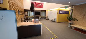 Sim Center foyer, desk and seating with tape markings on the floor.